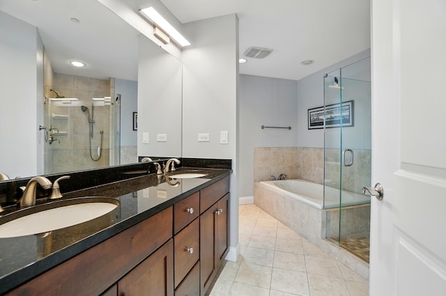 400 Riverboat Row Unit 605, Newport, KY 41071 - full bathroom with tile patterned floors, a garden tub, double vanity, and a stall shower