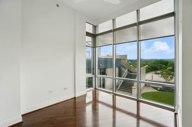 400 Riverboat Row Unit 605, Newport, KY 41071 - empty room featuring a wall of windows, wood finished floors, and baseboards