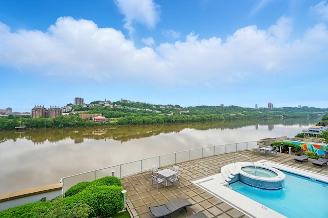 400 Riverboat Row Unit 605, Newport, KY 41071 - view of swimming pool with a pool with connected hot tub, a water view, a patio area, and a view of city
