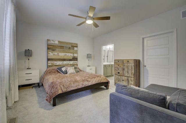 carpeted bedroom featuring ceiling fan and ensuite bath