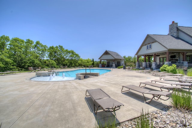 view of swimming pool featuring a patio and pool water feature