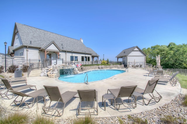 view of pool with a patio and pool water feature