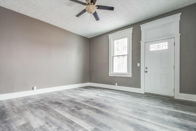 entrance foyer with ceiling fan, light hardwood / wood-style floors, and a textured ceiling