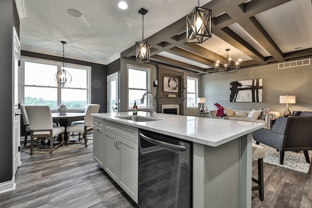 kitchen with sink, an island with sink, and pendant lighting