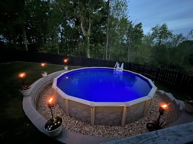 view of pool at dusk