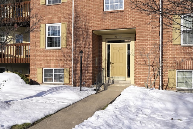 view of snow covered property entrance