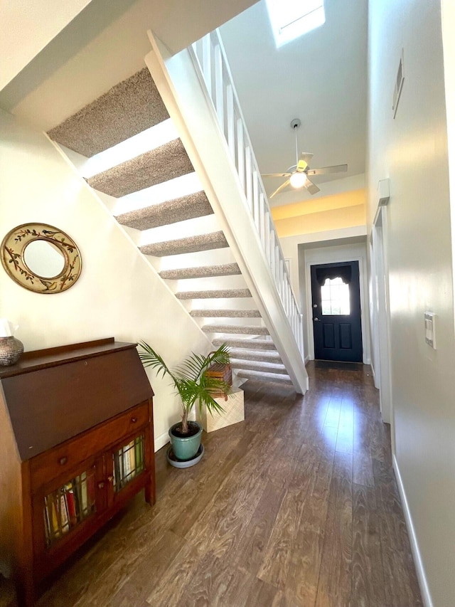 foyer with dark hardwood / wood-style floors and ceiling fan