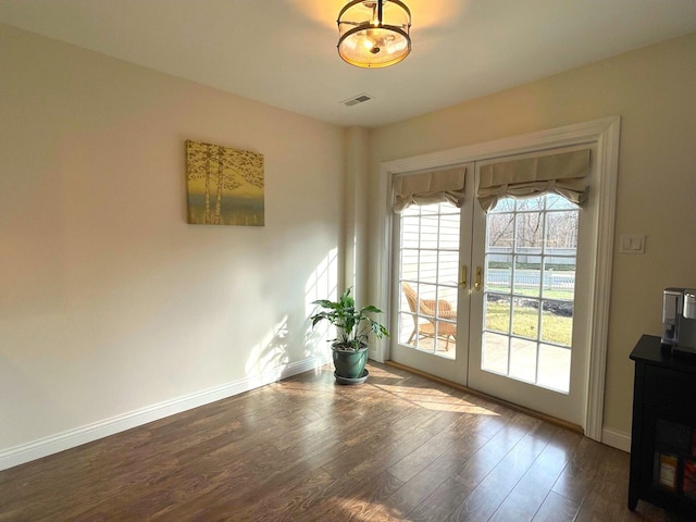 doorway with dark hardwood / wood-style flooring and french doors