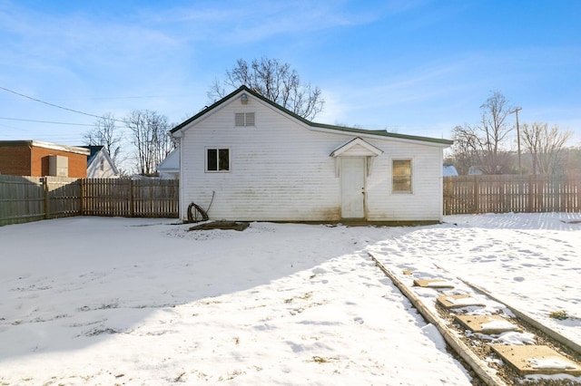 view of snow covered rear of property