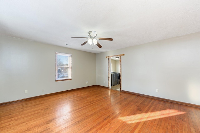 spare room featuring ceiling fan and light hardwood / wood-style flooring