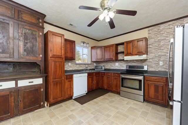 kitchen featuring a textured ceiling, stainless steel appliances, backsplash, ornamental molding, and ceiling fan