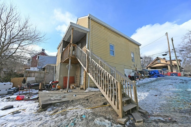 view of snow covered rear of property