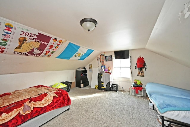 carpeted bedroom with lofted ceiling