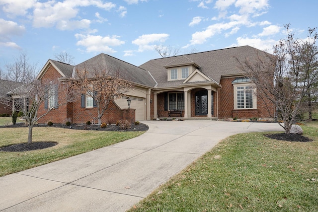 view of front of property featuring a garage and a front yard