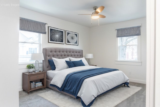 carpeted bedroom with ceiling fan and multiple windows