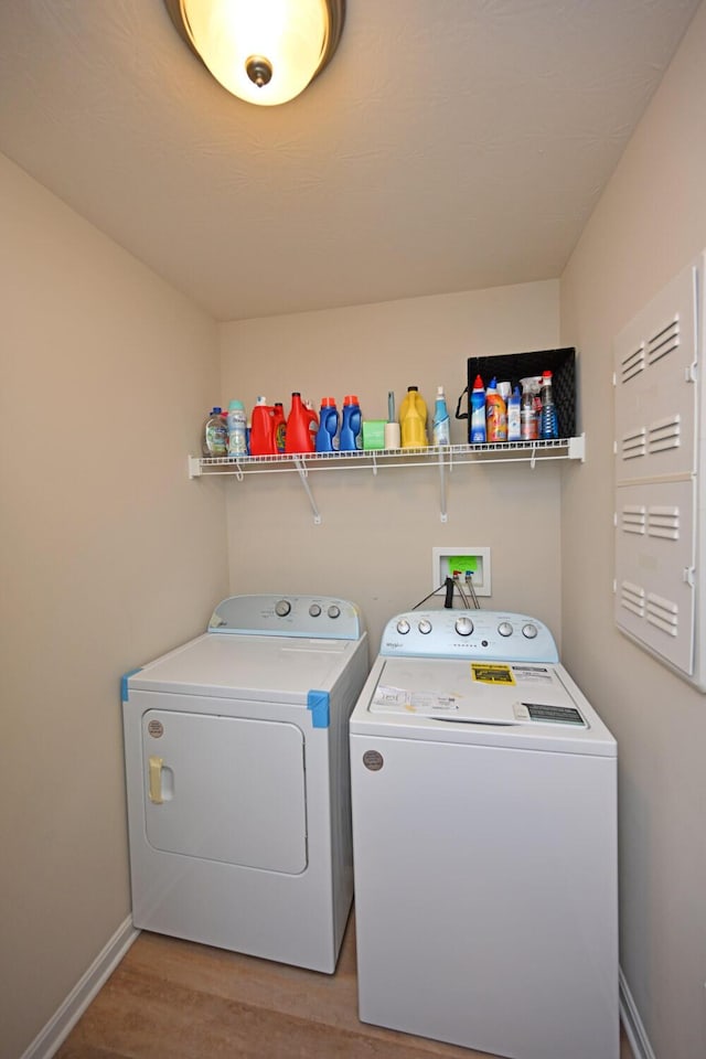 laundry room featuring hardwood / wood-style flooring and separate washer and dryer