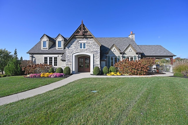 view of front of property featuring a front lawn and french doors