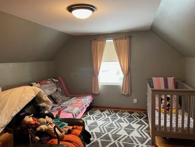 bedroom featuring lofted ceiling and carpet flooring