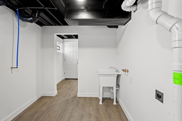 laundry room with hardwood / wood-style floors