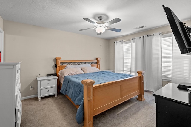 bedroom with ceiling fan and light carpet