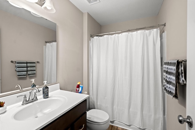 full bathroom with vanity, hardwood / wood-style floors, shower / tub combo with curtain, and toilet