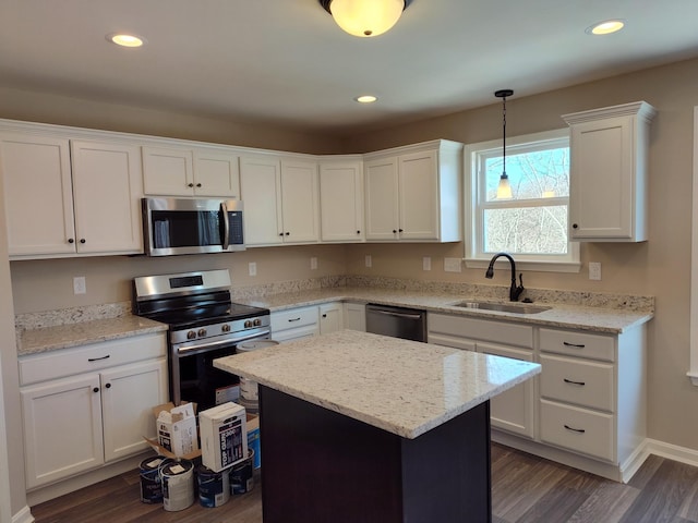 kitchen featuring a kitchen island, white cabinetry, sink, dark hardwood / wood-style flooring, and stainless steel appliances