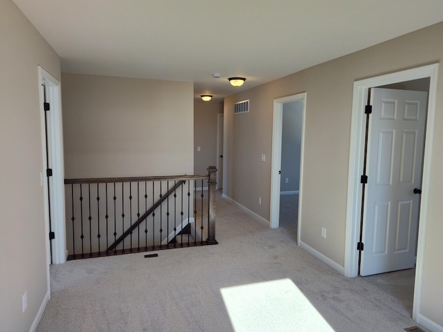 spare room featuring light colored carpet