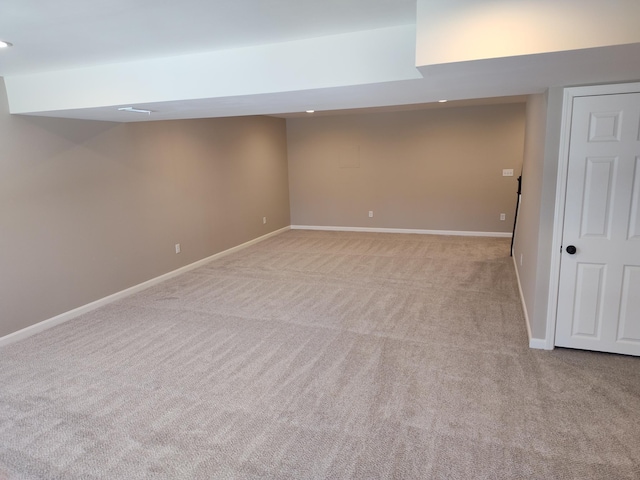 basement featuring light carpet