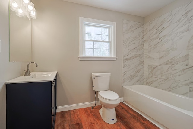 full bathroom with vanity, wood-type flooring, tiled shower / bath, and toilet