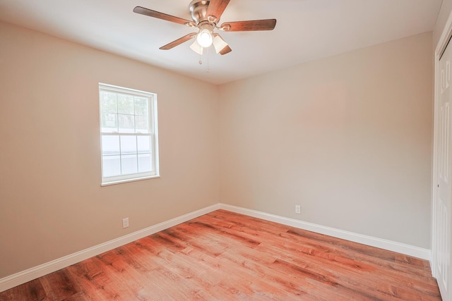 empty room with ceiling fan and light hardwood / wood-style flooring