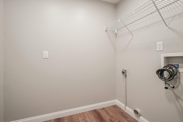 laundry area featuring electric dryer hookup, hardwood / wood-style floors, and hookup for a washing machine