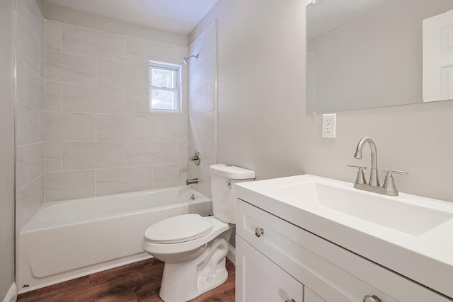 full bathroom with vanity, toilet, tiled shower / bath combo, and hardwood / wood-style floors