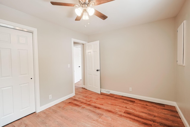 unfurnished bedroom with ceiling fan and light hardwood / wood-style floors