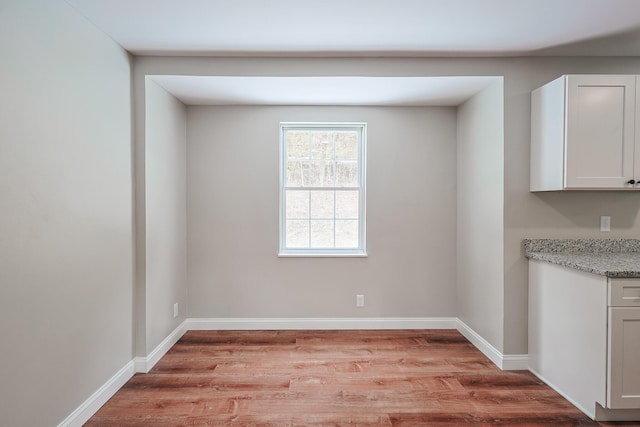 unfurnished dining area with light wood-type flooring