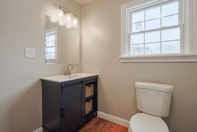 bathroom featuring hardwood / wood-style flooring, vanity, and toilet