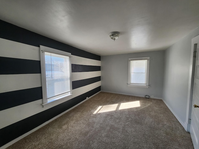 carpeted empty room featuring a wealth of natural light