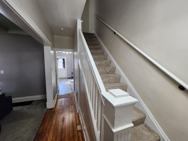 staircase with hardwood / wood-style floors