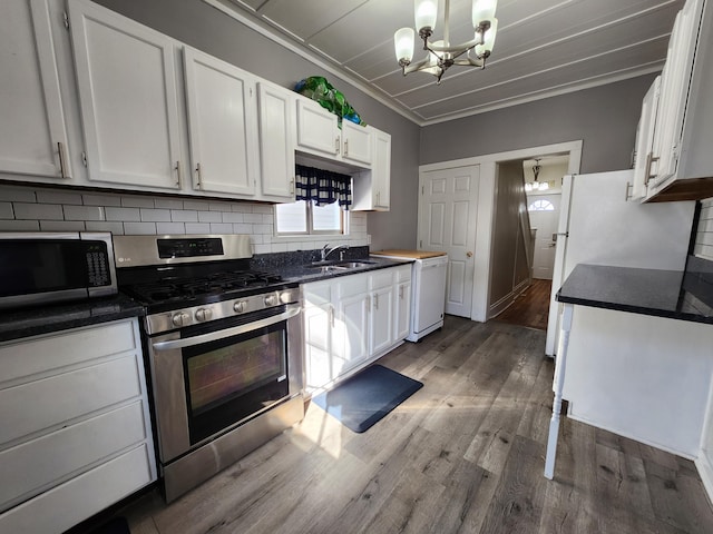 kitchen with ornamental molding, white dishwasher, gas stove, and white cabinets