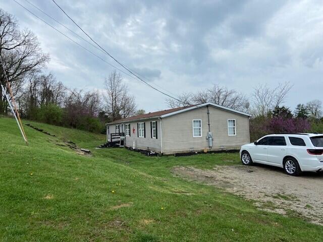 view of side of property with a lawn