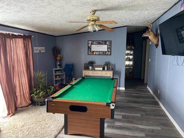 rec room with ceiling fan, pool table, dark wood-type flooring, and a textured ceiling