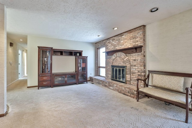 unfurnished living room with a brick fireplace, light carpet, and a textured ceiling