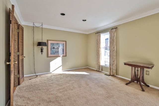 unfurnished room with crown molding and light carpet