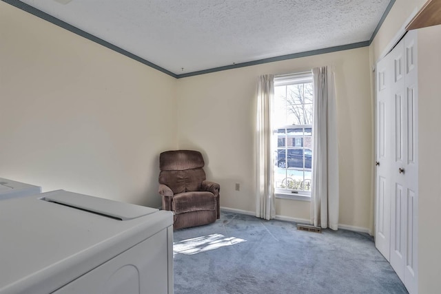 living area with light carpet, crown molding, washing machine and dryer, and a healthy amount of sunlight