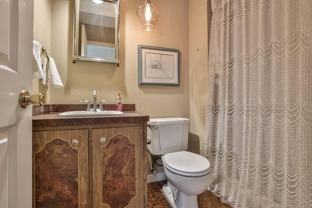 bathroom with vanity, tile patterned floors, and toilet