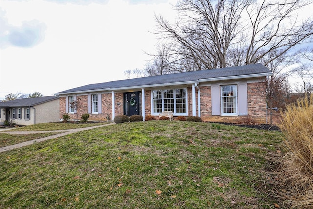 ranch-style house featuring brick siding and a front yard