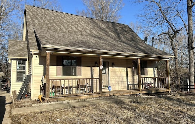 view of front facade featuring a porch and roof with shingles