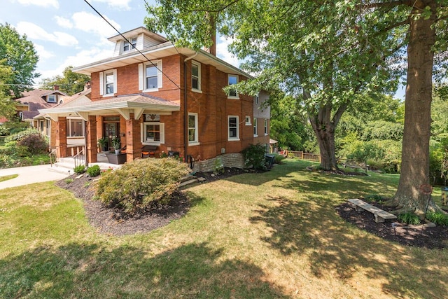 view of front of property with a porch and a front yard