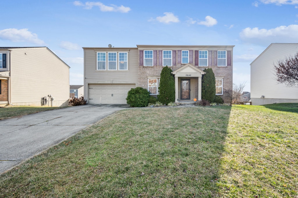 view of front of property featuring a garage and a front lawn