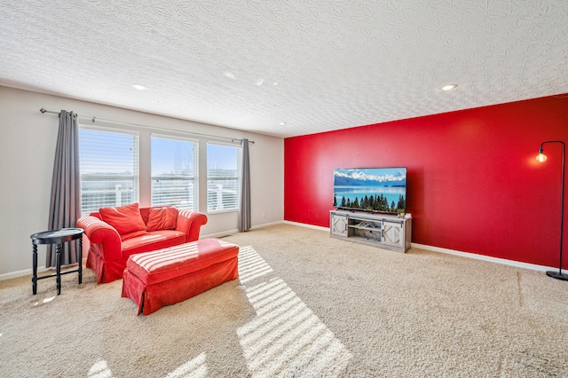 carpeted living room featuring a textured ceiling