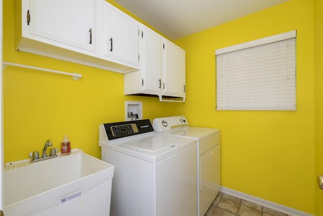 clothes washing area featuring cabinets, separate washer and dryer, and sink